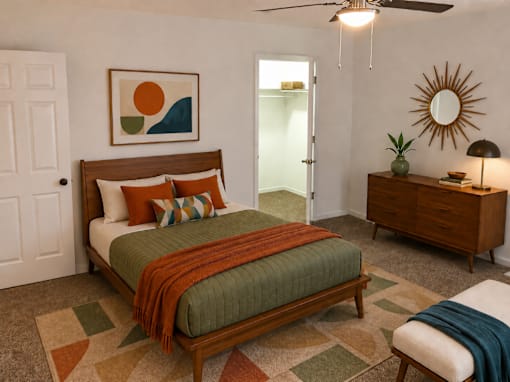 A bedroom with a bed, dresser, and mirror.