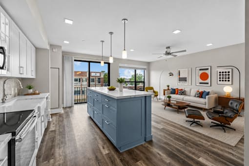 A modern kitchen with a large island and a view of the outdoors.