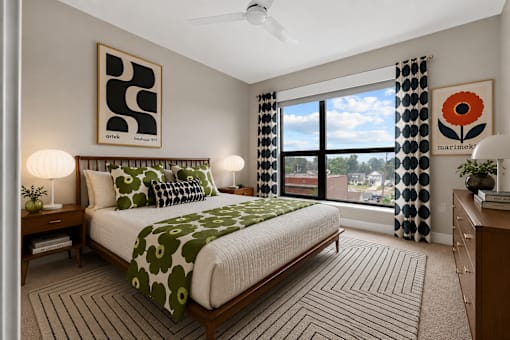 A bedroom with a large bed and a ceiling fan.