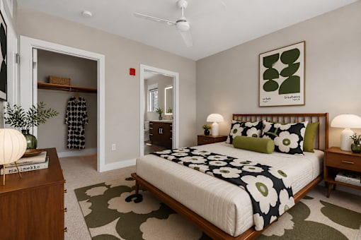 A bedroom with a bed, nightstands, and a rug.