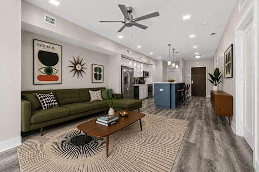 A living room with a green couch and a coffee table.