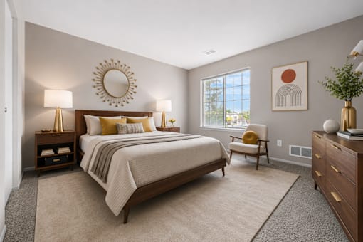 Modern bedroom with natural light and wood furniture at Village Club of Farmington Hills Apartments, Michigan