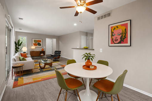Open concept dining and living area with modern furnishings at Village Club of Farmington Hills Apartments, Farmington Hills, 48331