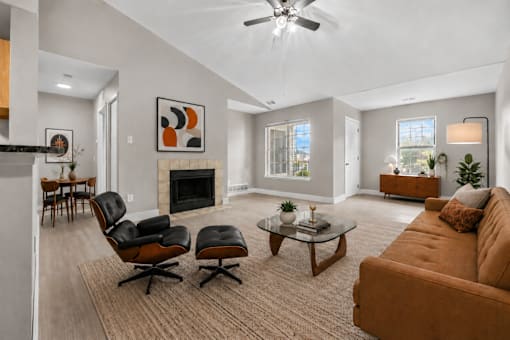 Spacious living room with vaulted ceiling and fireplace at Village Club of Farmington Hills Apartments, Farmington Hills, Michigan