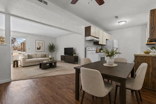 A modern dining room with a wooden table and chairs.