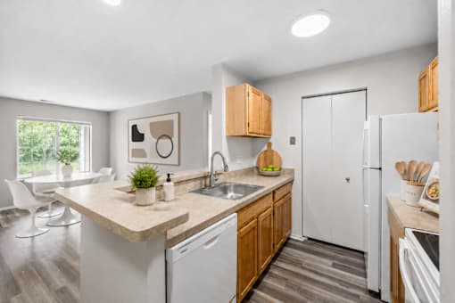 A kitchen with a white fridge and wooden cabinets.