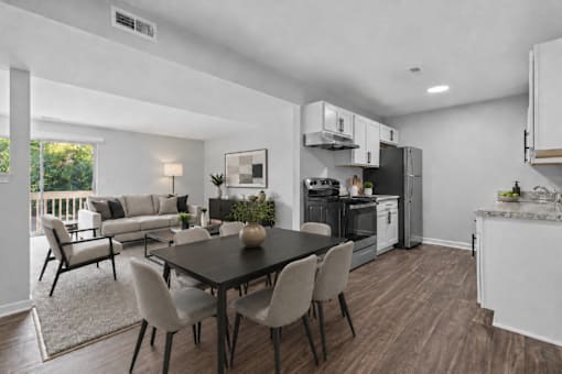 A modern kitchen with a dining table and chairs.