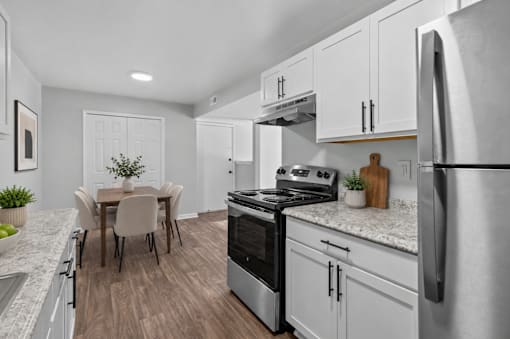 A modern kitchen with a dining table and chairs.