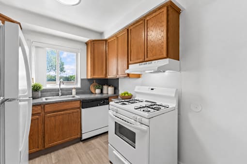 A white stove and oven in a kitchen with wooden cabinets.