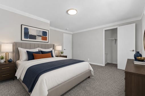 A bedroom with a large bed and a painting on the wall.