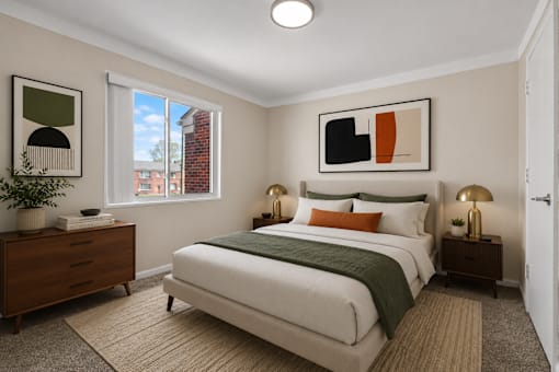 A bedroom with a large bed and a painting on the wall.