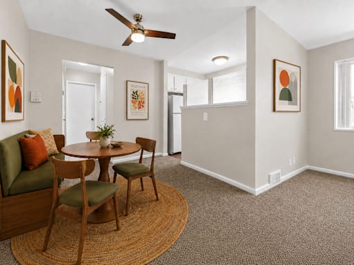 A living room with a round table and chairs.
