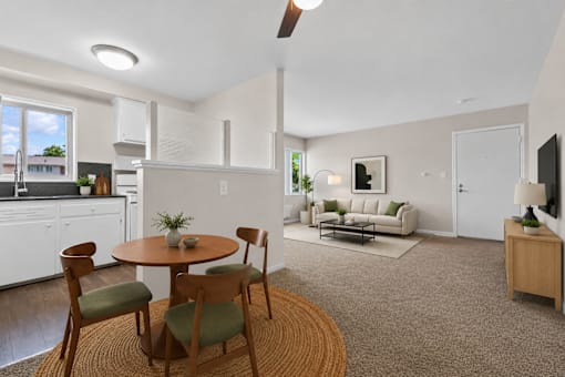 A kitchen with a table and chairs in the middle of the room.