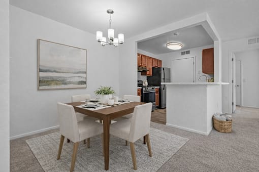 A dining room with a wooden table and chairs.