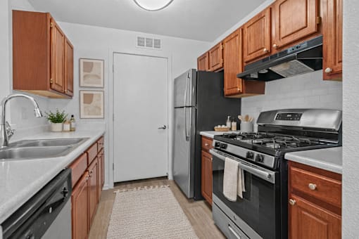 A kitchen with a black stove top oven and a black refrigerator.