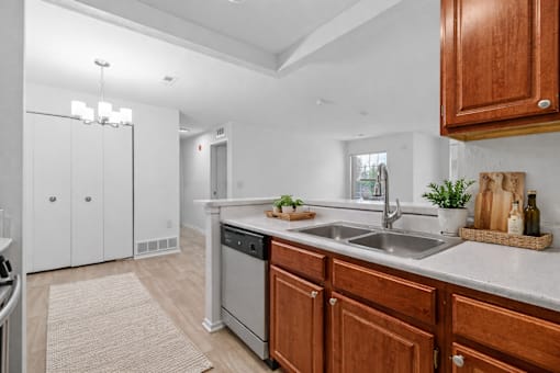 A kitchen with wooden cabinets and a white countertop.