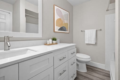A bathroom with a white toilet and a white sink.