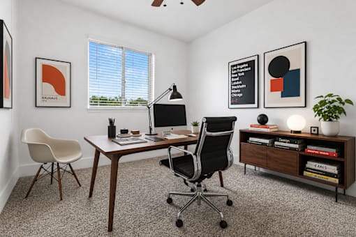 A modern home office with a desk, chair, and bookshelf.