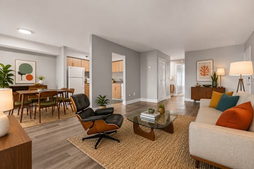 A modern living room with a black chair and a glass coffee table.