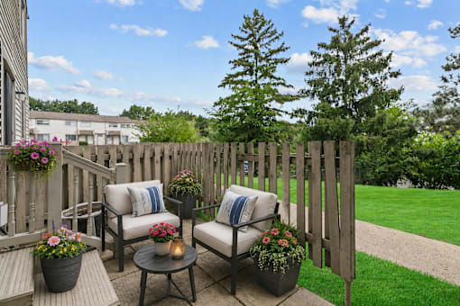 A backyard patio with a table and chairs.