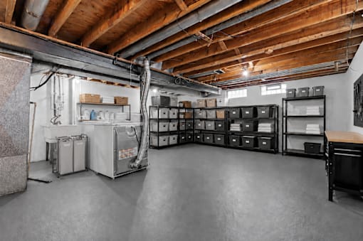 A large, empty warehouse with a concrete floor and wooden ceiling.