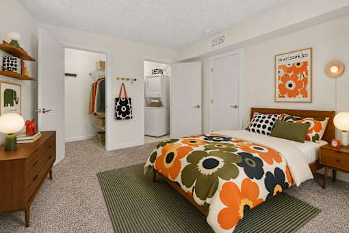 A bedroom with a bed, nightstand, and a lamp.