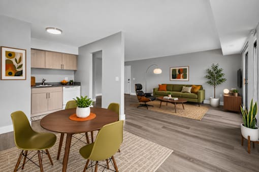 A modern dining room with a round table and chairs.