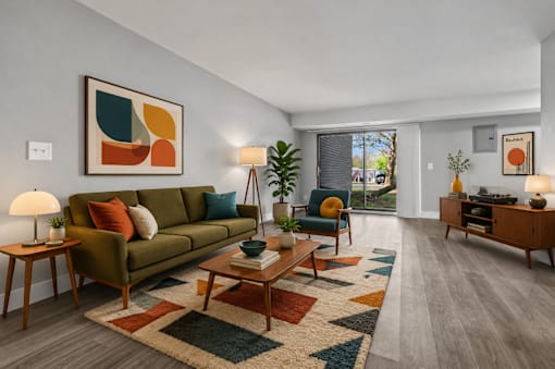 A living room with a green couch, a coffee table, and a rug.