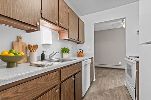 A kitchen with wooden cabinets and white appliances.
