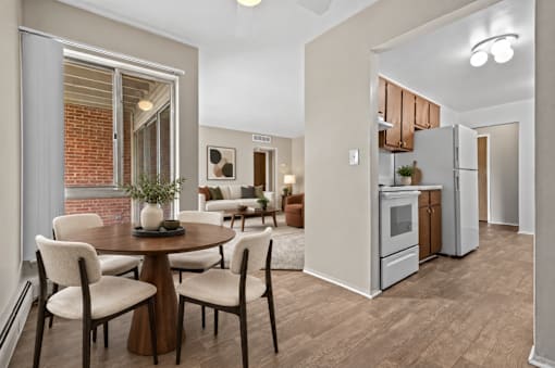 A modern kitchen with a dining table set for four.