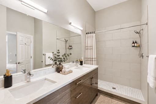 A bathroom with a white sink and a white counter top.