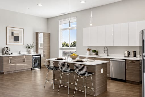 A modern kitchen with a dining table and chairs.