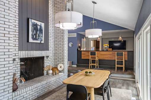 A dining room with a wooden table and chairs.