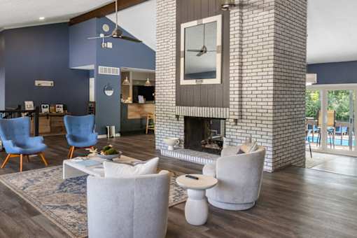 A living room with a fireplace and a large mirror above it.