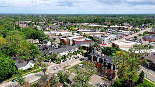A small town with a lot of greenery and buildings.