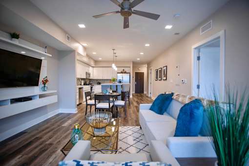 a living room with a couch and a ceiling fan