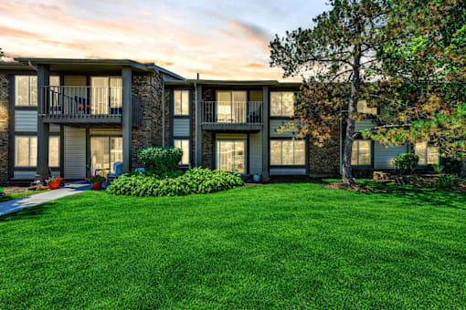A building with a green lawn in front of it.