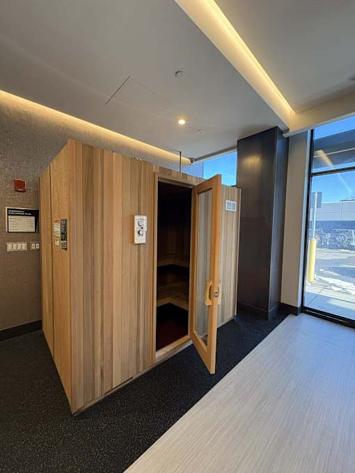 A wooden room divider with a door open to a hallway.