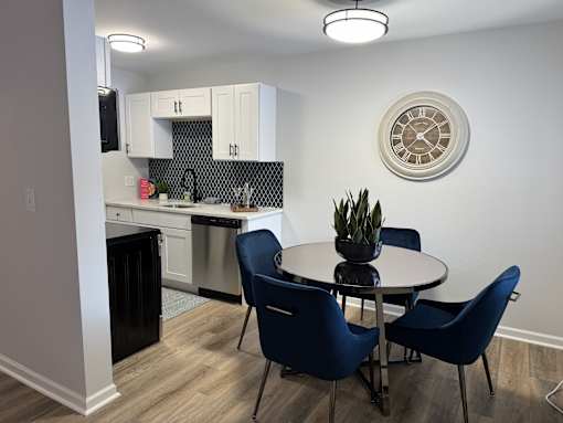 A kitchen with a dining table and chairs. at The Park on 13 Apartments - Royal Oak, MI Apartments, Royal Oak, Michigan