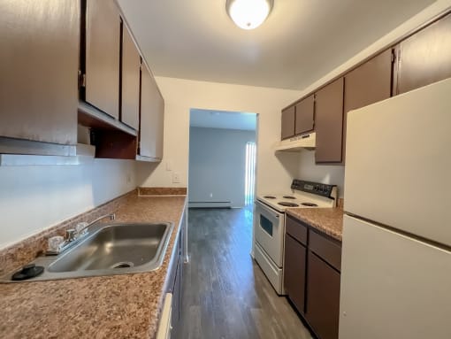a kitchen with brown cabinets and a white stove top oven