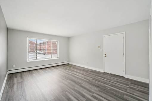A room with a window and a door.