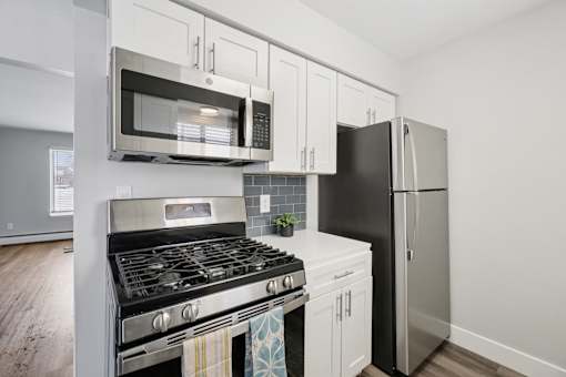 A modern kitchen with a black stove top oven and a black refrigerator.