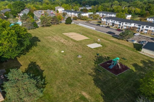 an aerial view of a basketball court on a grass field