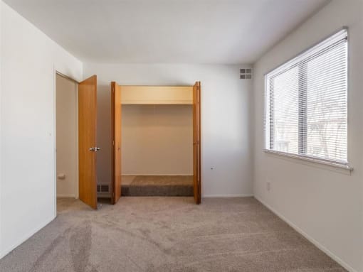 a bedroom with an open door and a window