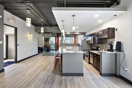 an open kitchen and living room with a large island at Troy Place Apartments - Troy, MI, Troy, Michigan