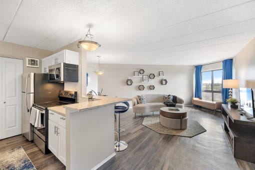 a kitchen and living room with a counter top at Troy Place Apartments - Troy, MI, Troy, Michigan