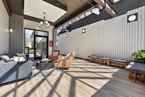 the lobby of a building with a couch and chairs at Troy Place Apartments - Troy, MI, Troy