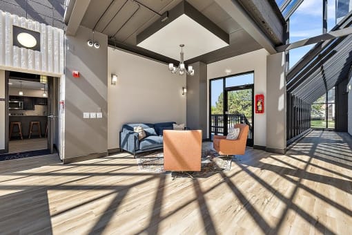 a living room with a couch and two chairs at Troy Place Apartments - Troy, MI, Michigan