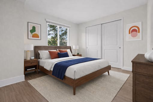 A bedroom with a bed, nightstands, and two framed pictures on the wall.