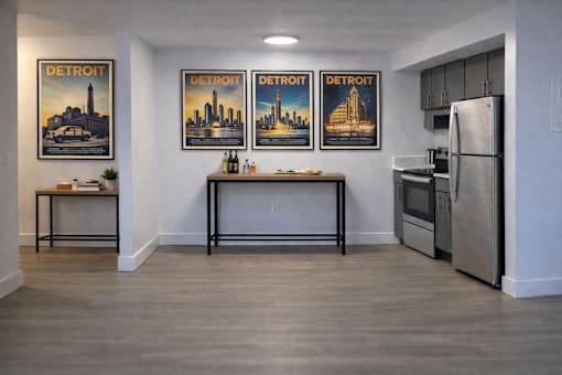 A kitchen with three posters of Detroit on the wall.